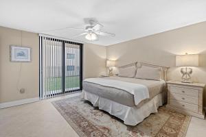 a bedroom with a bed and a ceiling fan at Sunrise 109 in New Smyrna Beach +48 photos
