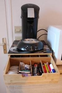 a coffee maker sitting on top of a wooden drawer at Studio 211 au cœur du campus de Belle Beille in Angers +13 photos