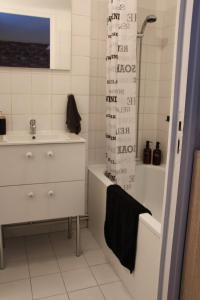 a bathroom with a sink and a tub and a shower at Studio 211 au cœur du campus de Belle Beille in Angers