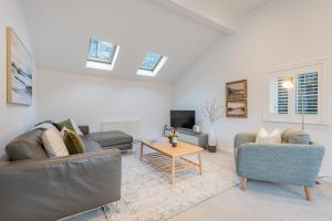 a living room with a couch and a table at The Old Weigh House in Kirkby Lonsdale