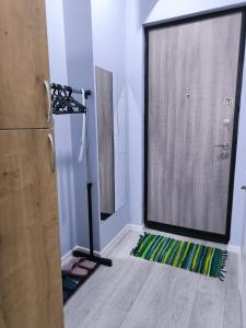 a bathroom with a shower and a rug on the floor at Willy's House in Batumi +4 photos