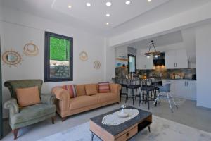 a living room with a couch and a table at Villa Montana 1 in Fethiye