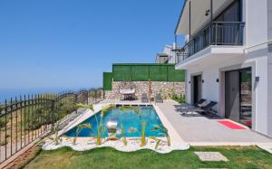 a house with a swimming pool in the yard at Villa Montana 1 in Fethiye