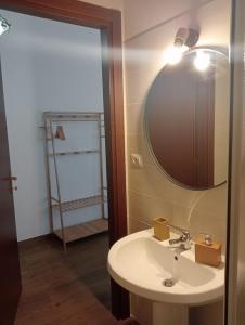 a bathroom with a sink and a mirror at il Guardiano delle due Baie Domus in SantʼAntìoco +70 photos