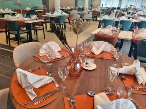 a dining room with a table with glasses and napkins at DOMITYS - Les Vantelles in Plombières-lès-Dijon