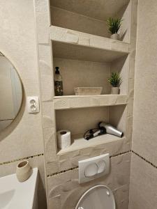 a small bathroom with a toilet and a sink at DiVino in Mostar
