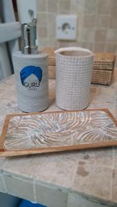 a cutting board and a container on a counter at Guru Canggu in Canggu