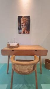 a wooden desk with a picture on the wall at Guru Canggu in Canggu