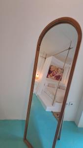 a mirror reflection of a bedroom with a bunk bed at Guru Canggu in Canggu