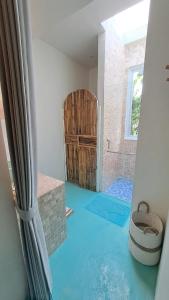 a view of a bathroom with a blue floor at Guru Canggu in Canggu