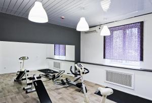 a gym with treadmills and cardio equipment in a room at Maxi House Hostel in Rostov on Don