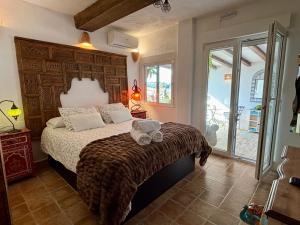 a bedroom with a bed with a large wooden headboard at Hotel Altea Paradise 1917 - Adults Only in Altea +37 photos