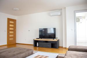 a living room with a large flat screen tv at Sarajevo Gate in Sarajevo