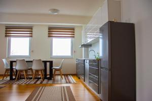 a kitchen and dining room with a table and chairs at Sarajevo Gate in Sarajevo +16 photos