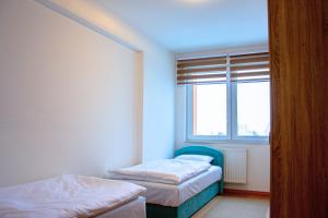 a bedroom with two beds and a window at Sarajevo Gate in Sarajevo
