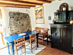 a dining room with a blue table and chairs at Ferienwohnungen Willrich in Blankenheim