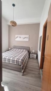 Ένα ή περισσότερα κρεβάτια σε δωμάτιο στο Ca'VI comfortable and cute house