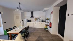Una cocina y un comedor con mesa y sillas. en Precioso apartamento con patio centro de Castropol, en Castropol