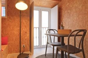 a dining room with a table and chairs and a window at Friendly Border City Design Apartments in Lisbon