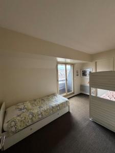 a bedroom with a bed and a window at Triangle d Or in Deauville