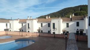 a house with a swimming pool in front of it at Beautiful Duplex with a Patio in Alcalá de los Gazules