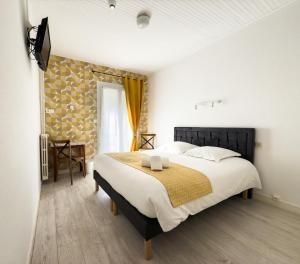 um quarto com uma cama grande em um quarto em Hotel de Paris em La Rochelle