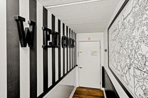 a hallway with black and white art on the walls at Corner Unit Balcony Free Tix Gatlinburg in Gatlinburg