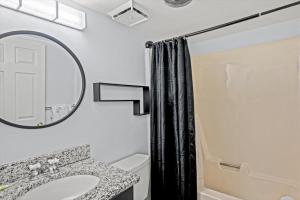 a bathroom with a sink and a mirror at Corner Unit Balcony Free Tix Gatlinburg in Gatlinburg