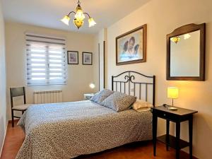 a bedroom with a bed and a table with a lamp at Casa Rural Las Condesas in Santo Domingo de Silos +24 photos