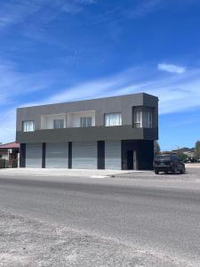 a black car parked in front of a building at Atuel Alojamiento in San Antonio Oeste
