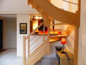 a wooden staircase in a room with a bedroom at Cute Little House - gîte classé 3 étoiles - 200 m gare - parking privé in Rouen