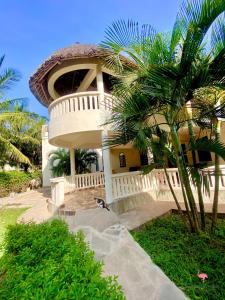 ディアニ・ビーチにあるEnchanting 3bed Villa with Ac &poolの前にヤシの木がある建物