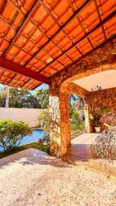 a large stone building with a wooden roof at Sua Casa na Serra in Itaipava