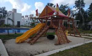 a playground with a slide in a park at Casas Marina Turquesa in Cancún