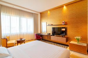 Uma televisão e/ou sistema de entretenimento em Asiana Hotel Dubai