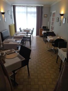 a row of tables and chairs in a restaurant at L'Orangerie in Soudan