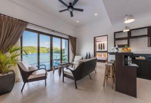 a living room with a view of the water at Busuanga Bay Lodge in Busuanga