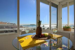 a table with a pineapple and two glasses of wine at Capri 403 in Torrox Costa
