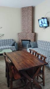 a living room with a wooden table and a fireplace at bakuriani in Bakuriani