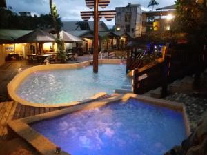 a large swimming pool at night with the lights on at Cocos Hot Spring Hotel in Ruisui
