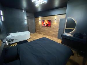 a bathroom with a bed and a sink and a mirror at Douce Nuit & Spa in Dorlisheim
