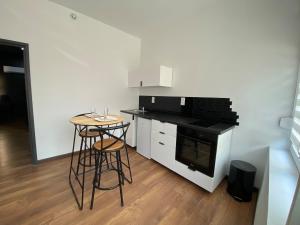 a kitchen with a table and a stove top oven at Douce Nuit & Spa in Dorlisheim