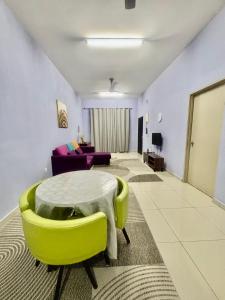 a living room with a table and a couch at H&Z Guesthouse Kulim Hi-Tech - Free Wifi - Netflix in Kulim