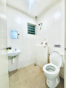a bathroom with a toilet and a sink at H&Z Guesthouse Kulim Hi-Tech - Free Wifi - Netflix in Kulim +26 photos