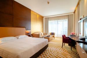 Uma cama ou camas num quarto em Asiana Hotel Dubai
