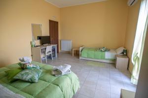 Postel nebo postele na pokoji v ubytování B&B LAVIKA PEDARA
