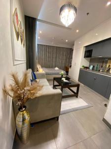 a living room with a couch and a table at Luxury Vello Stay Supernova in New Delhi