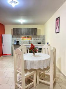 a kitchen with a table and chairs and a refrigerator at departamento don Pedro 2 in Posadas +4 photos