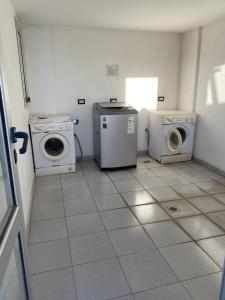 a laundry room with two washing machines and a washer and dryer at Dpto 9 DE JULIO in Villa María +6 photos