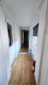 an empty room with a hallway with a hard wood floor at Central and Large cosey apartment in Stavanger